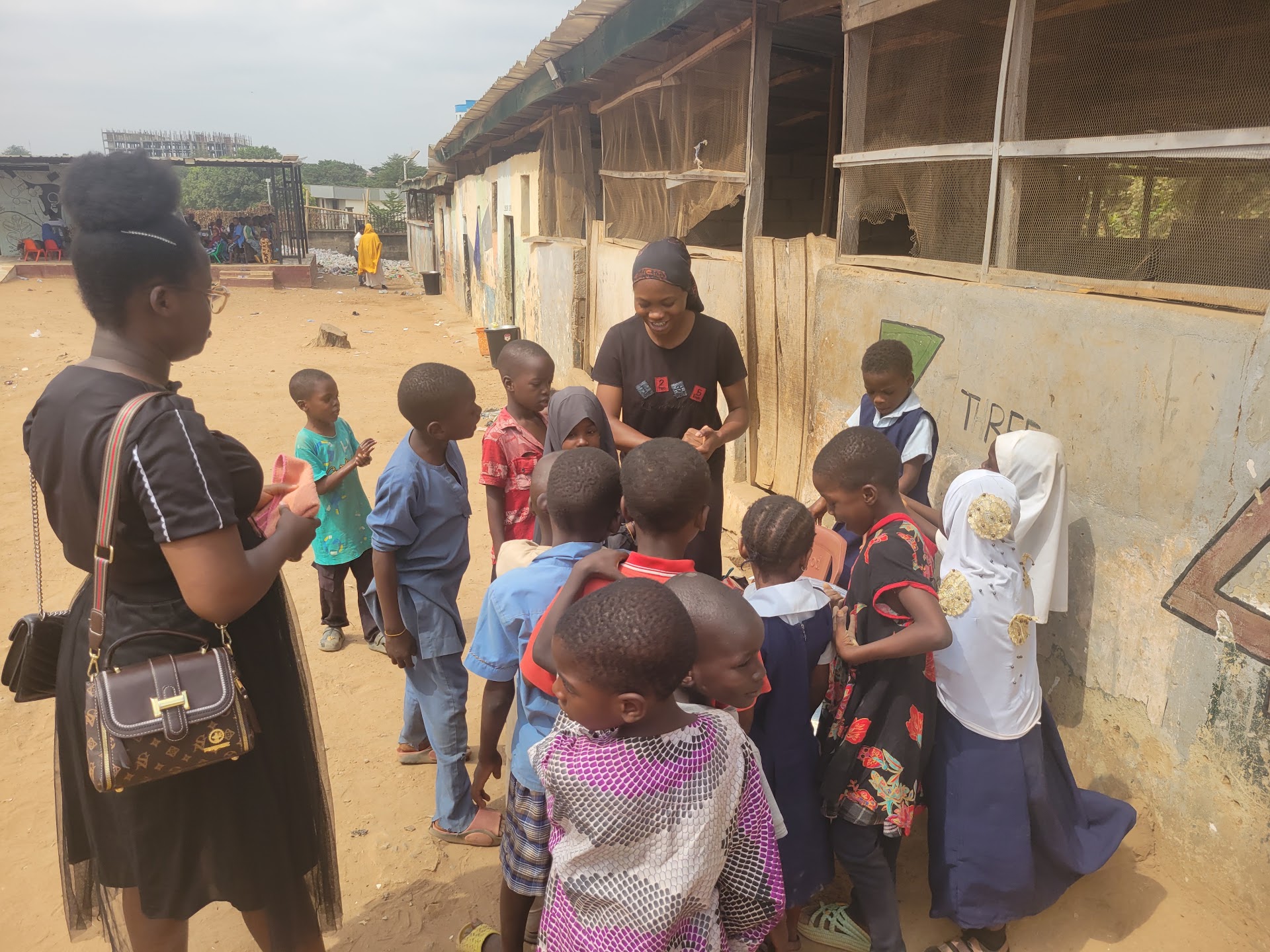 Jed Child Trust volunteer with children at IDP Outreach