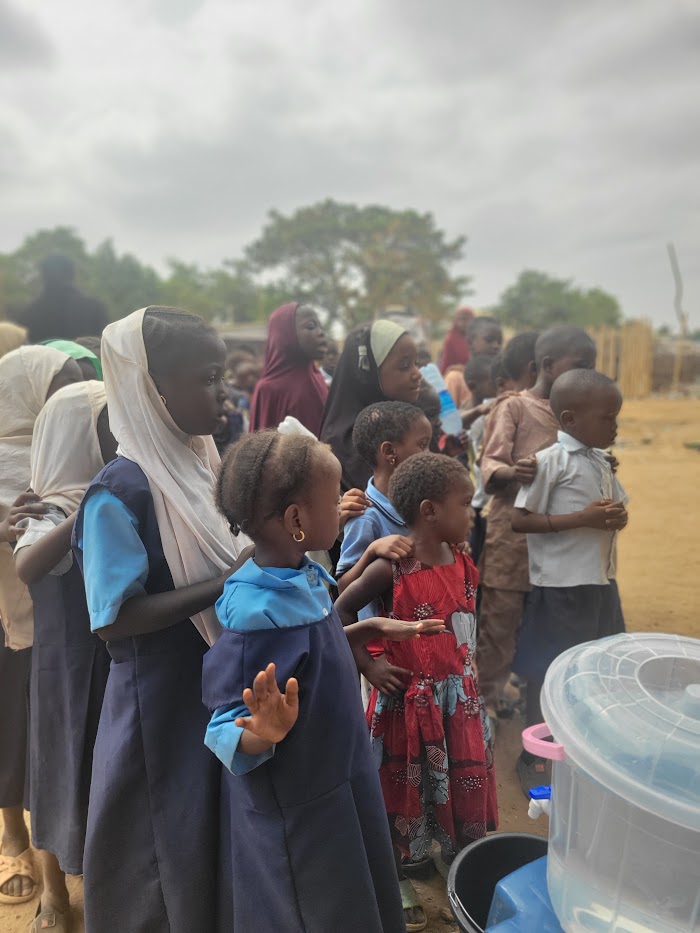 Children lining up at IDP Outreach