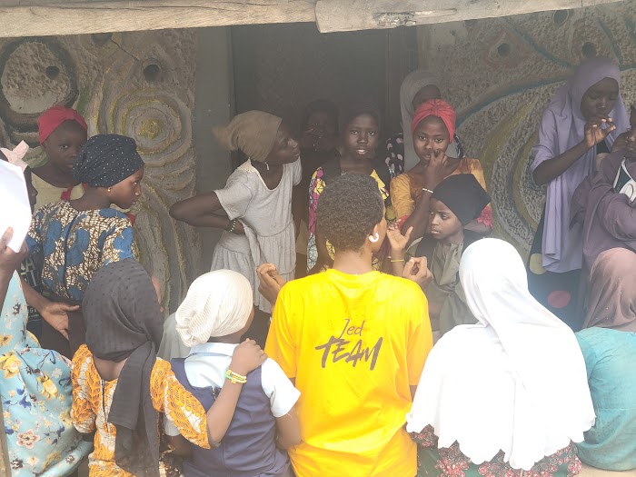 Jed Team volunteer with children at IDP Outreach