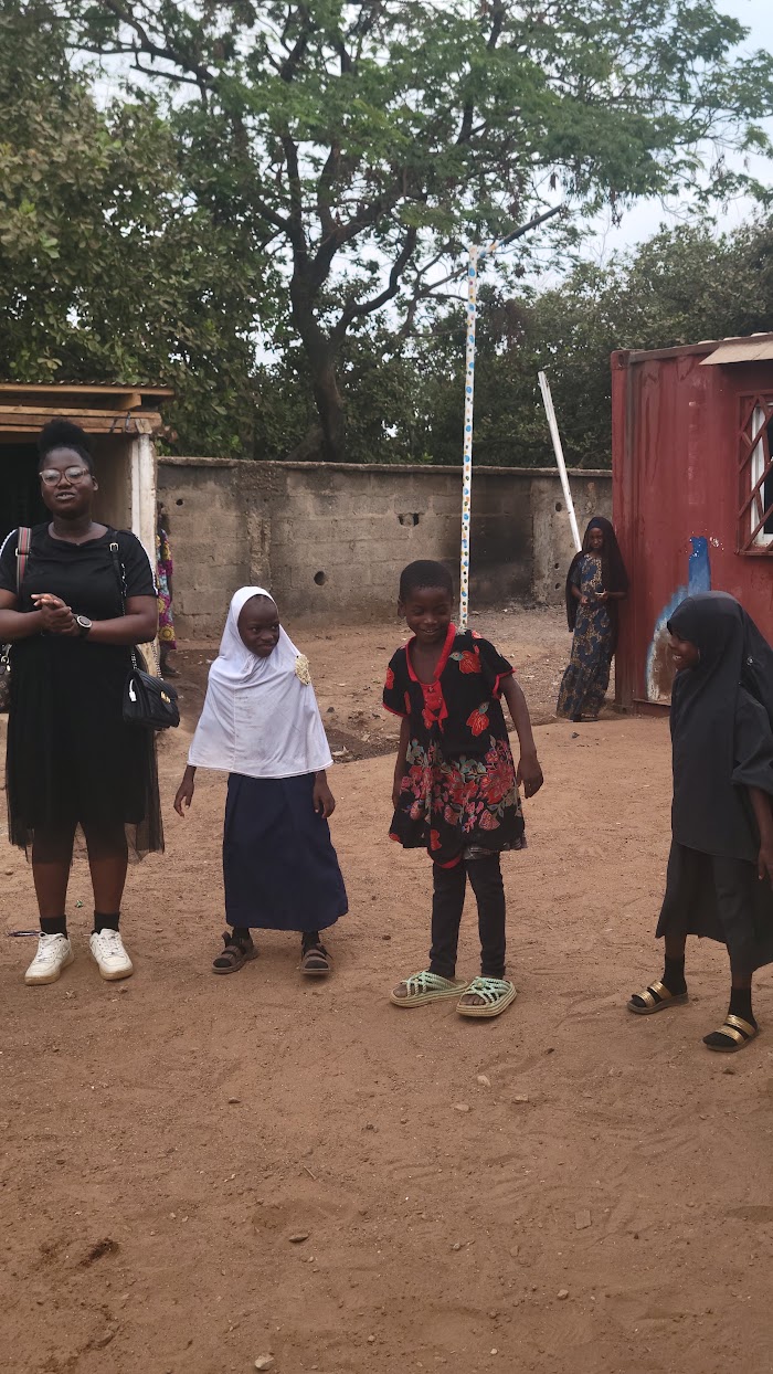 Volunteers and children outdoors at IDP Outreach